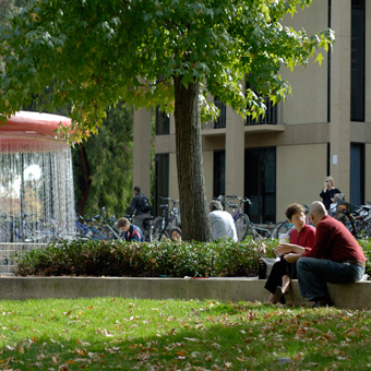 People outside by a fountain